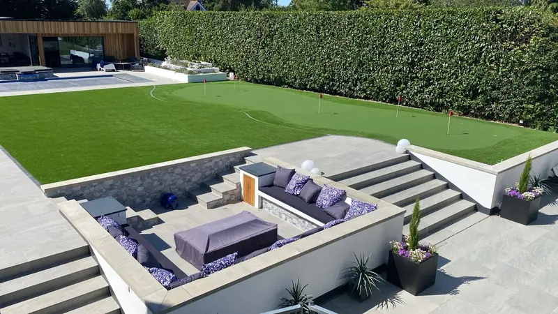 Sunken seating area with stone walls and wide steps up to the lawn
