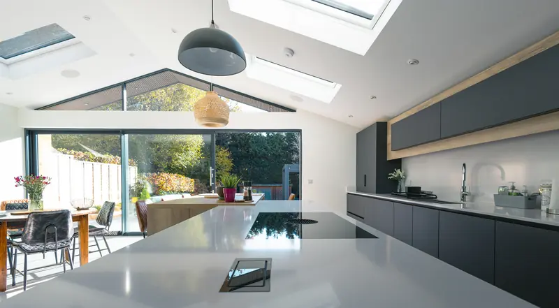 Vaulted kitchen extension with roof windows, a glazed gable and sliding doors to the garden